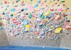 Rock climbing wall covered in holds