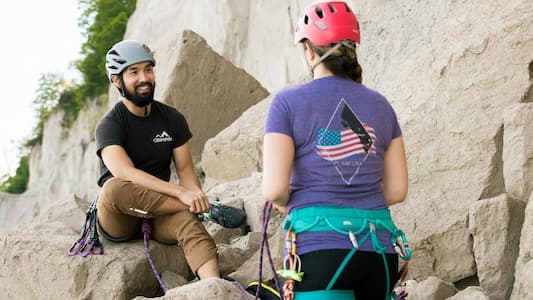 Two rock climbers in gear chatting